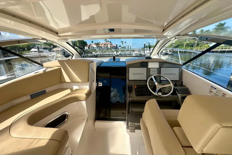  Yacht Photos Pics 2015 Pursuit SC 365i Sport Coupe interior with Garmin navigation, docked at marina.