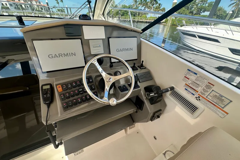  Yacht Photos Pics 2015 Pursuit SC 365i Sport Coupe helm with Garmin displays and control panel.