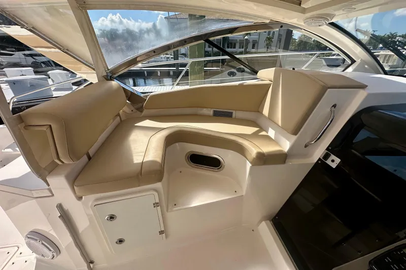  Yacht Photos Pics 2015 Pursuit SC 365i Sport Coupe interior with beige seating and marina view.