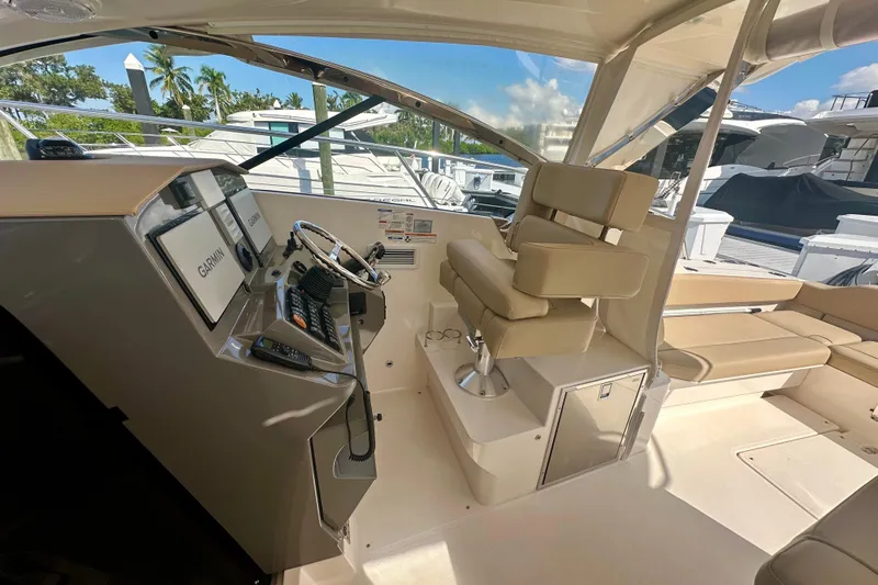  Yacht Photos Pics 2015 Pursuit SC 365i Sport Coupe helm with Garmin displays and beige seating.