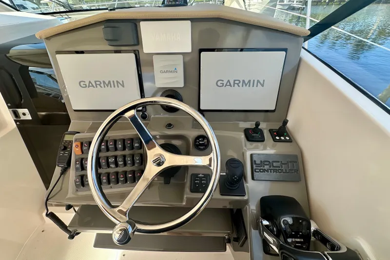  Yacht Photos Pics Control panel of 2015 Pursuit SC 365i Sport Coupe with Garmin displays and yacht controller.