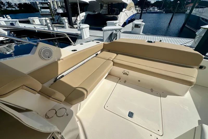  Yacht Photos Pics 2015 Pursuit SC 365i Sport Coupe interior with beige seating at marina.