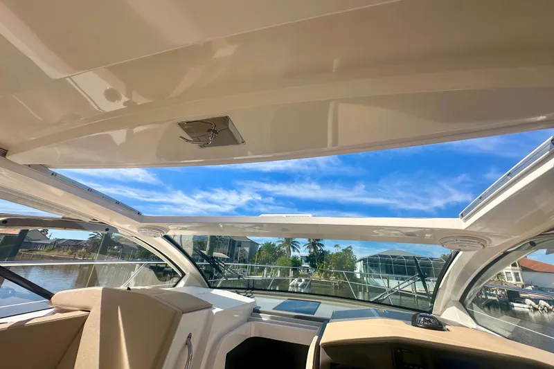  Yacht Photos Pics 2015 Pursuit SC 365i Sport Coupe interior with open sunroof, showcasing waterfront view.