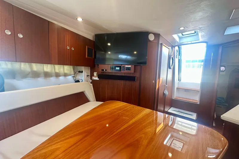  Yacht Photos Pics Interior of 2015 Pursuit SC 365i Sport Coupe with wood finish and modern amenities.