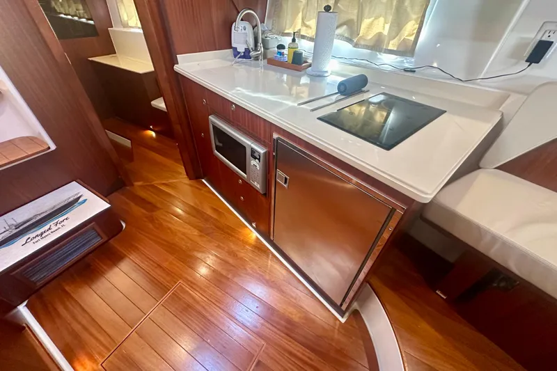  Yacht Photos Pics Luxurious 2015 Pursuit SC 365i Sport Coupe interior with modern kitchen amenities.