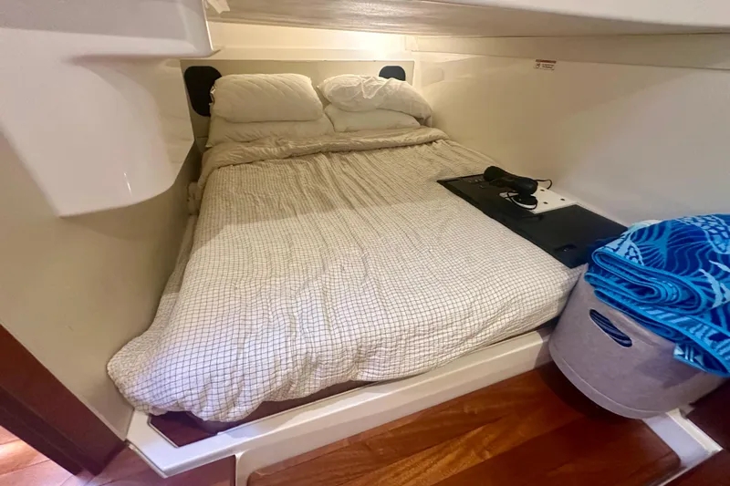  Yacht Photos Pics Cozy cabin interior of 2015 Pursuit SC 365i Sport Coupe with bed and storage.