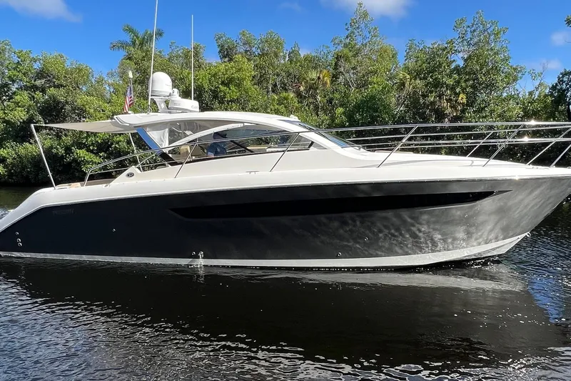  Yacht Photos Pics 2015 Pursuit SC 365i Sport Coupe yacht cruising on a serene waterway.