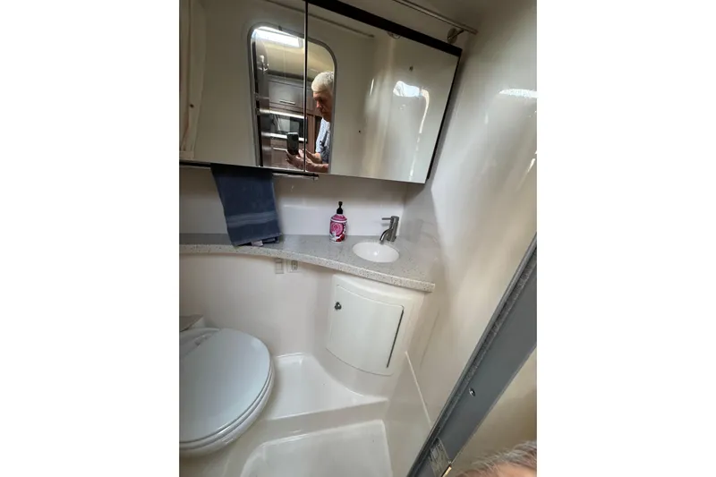 Don't Ask Yacht Photos Pics 2018 Regal 28 Express boat bathroom with sink, mirror, and toilet.