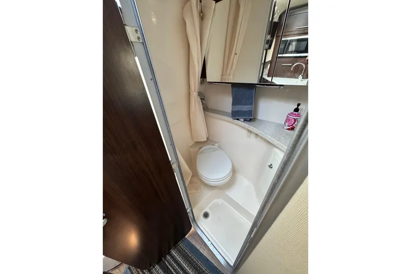 Don't Ask Yacht Photos Pics 2018 Regal 28 Express boat bathroom with toilet, shower, and mirror cabinet.