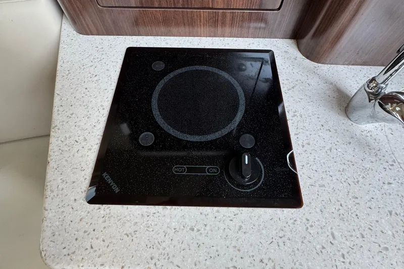 Don't Ask Yacht Photos Pics Kenyon cooktop on 2018 Regal 28 Express boat's white speckled countertop.