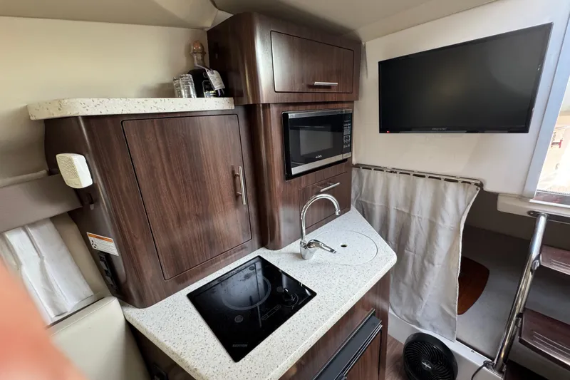 Don't Ask Yacht Photos Pics 2018 Regal 28 Express boat interior with kitchenette, microwave, and TV.