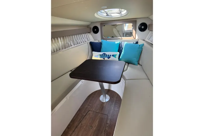 Don't Ask Yacht Photos Pics 2018 Regal 28 Express cabin interior with seating, table, and colorful cushions.