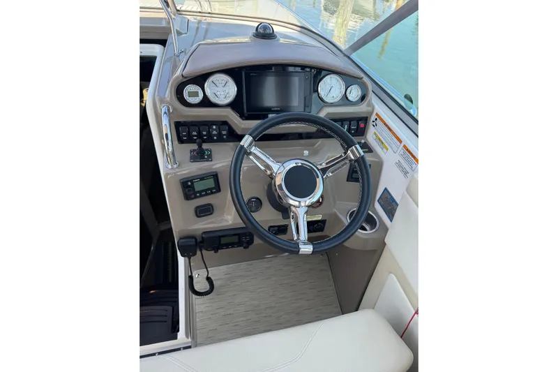 Don't Ask Yacht Photos Pics Cockpit of 2018 Regal 28 Express boat with steering wheel and control panel.
