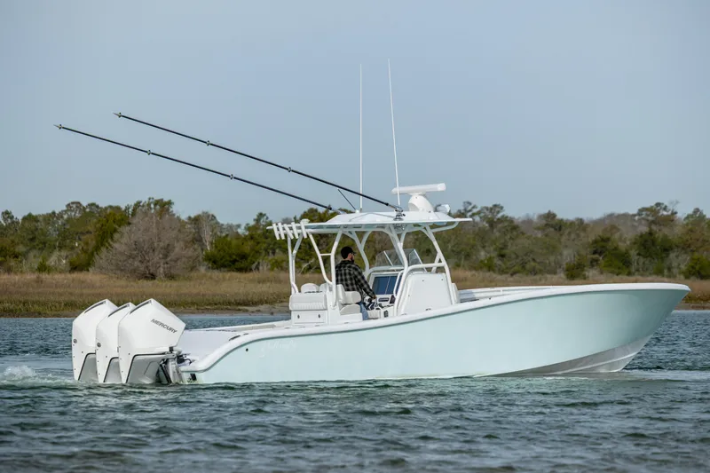  Yacht Photos Pics 2024 Yellowfin 34 Offshore boat cruising on a calm waterway.