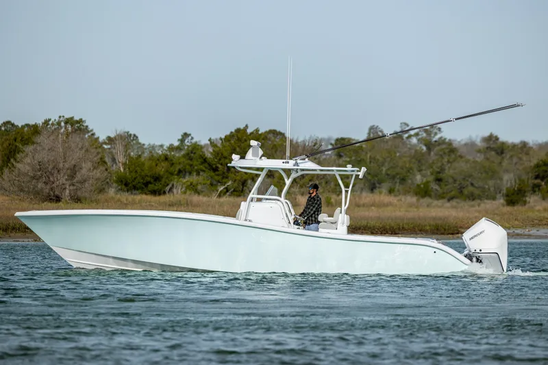  Yacht Photos Pics 2024 Yellowfin 34 Offshore boat cruising on calm waters, side view.
