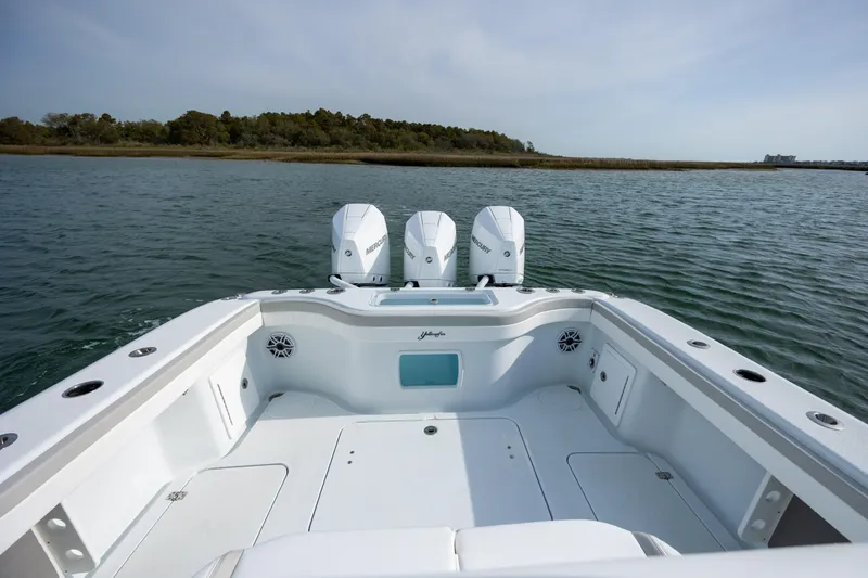  Yacht Photos Pics 2024 Yellowfin 34 Offshore boat with triple engines on calm water.
