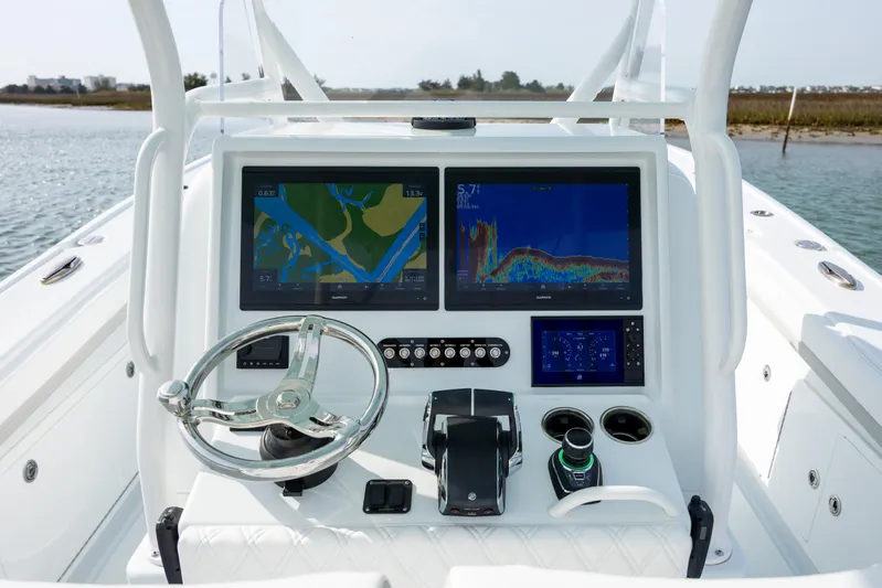  Yacht Photos Pics 2024 Yellowfin 34 Offshore boat dashboard with dual navigation screens and steering wheel.