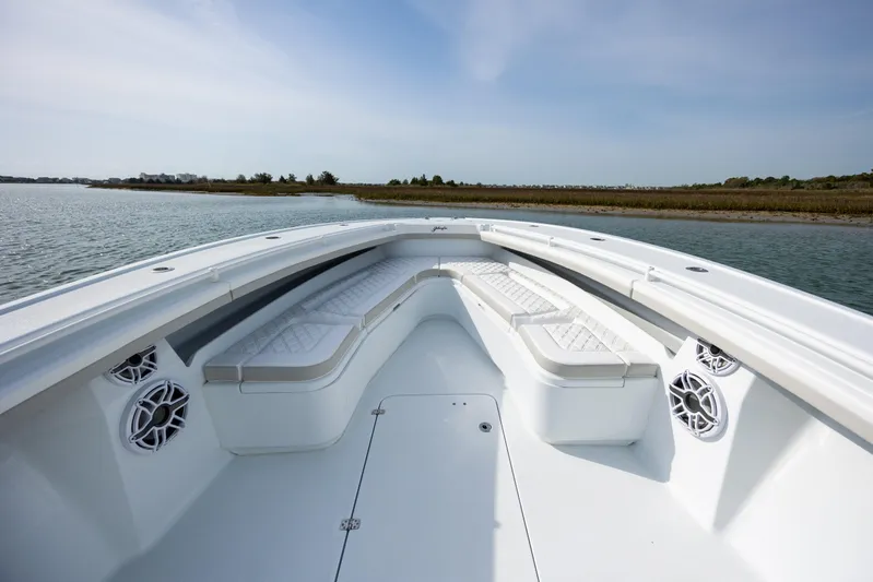  Yacht Photos Pics 2024 Yellowfin 34 Offshore boat with spacious seating and sleek design on calm water.