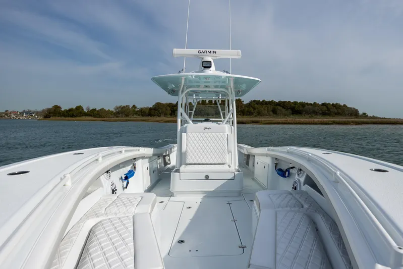  Yacht Photos Pics 2024 Yellowfin 34 Offshore boat on calm water, featuring sleek design and spacious deck.