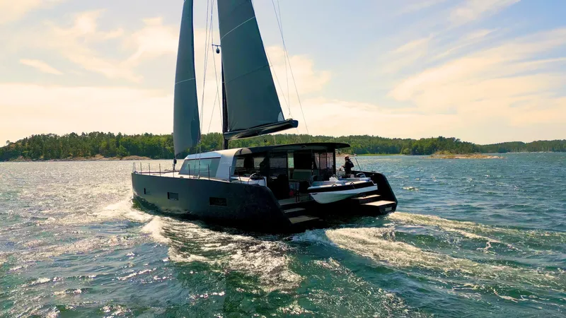  Yacht Photos Pics Sleek Vaan R5 yacht sailing on open water, 2025 model, under clear skies.