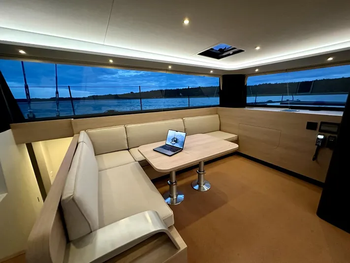  Yacht Photos Pics Luxurious interior of 2025 Vaan R5 yacht with elegant seating and scenic window view.