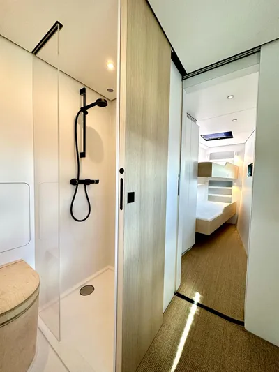  Yacht Photos Pics Modern Vaan R5 2025 yacht interior with sleek bathroom and cozy bunk beds.