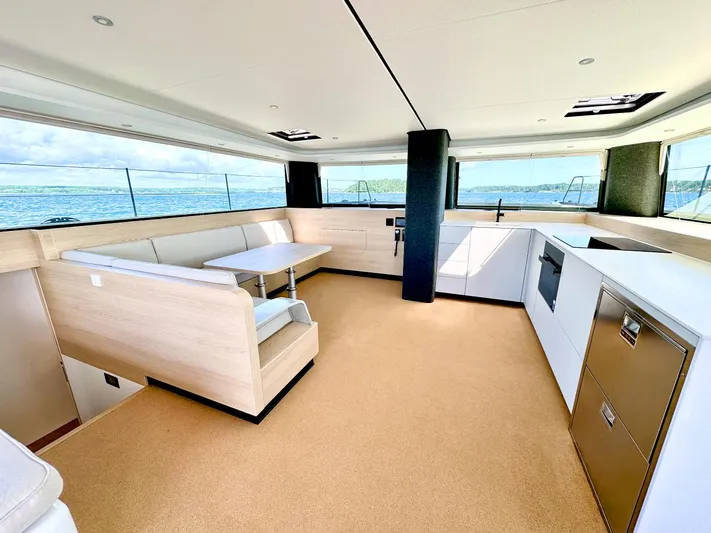  Yacht Photos Pics Luxurious interior of 2025 Vaan R5 yacht with modern kitchen and seating area.