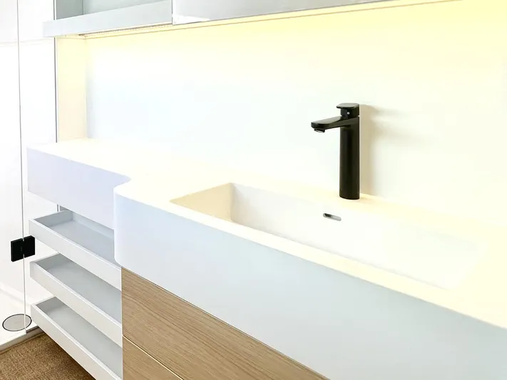 Yacht Photos Pics Modern bathroom sink with sleek black faucet, minimalist design, and wooden cabinetry.