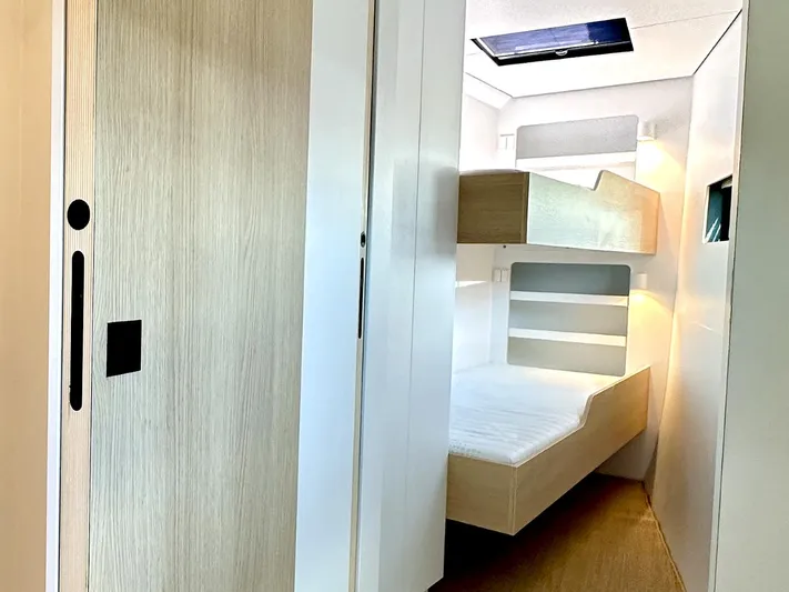  Yacht Photos Pics Modern Vaan R5 2025 interior with bunk beds and sleek wooden design.