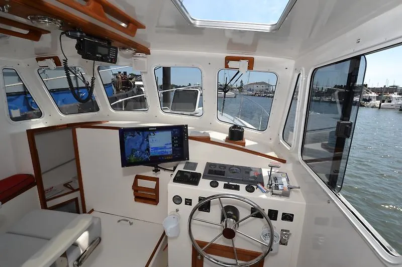 Grey Goose Yacht Photos Pics Interior of 2002 West Bay 31 boat with navigation equipment and steering wheel.