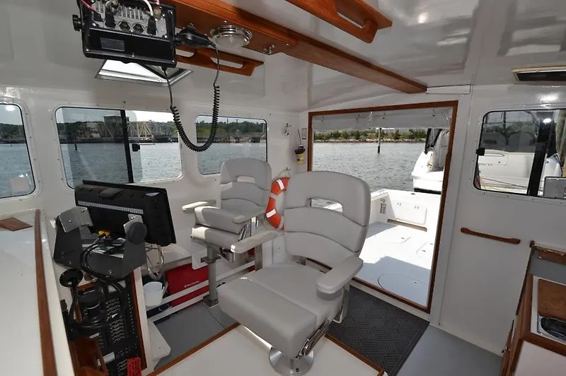 Grey Goose Yacht Photos Pics Interior of 2002 West Bay 31 boat with modern seating and navigation equipment.