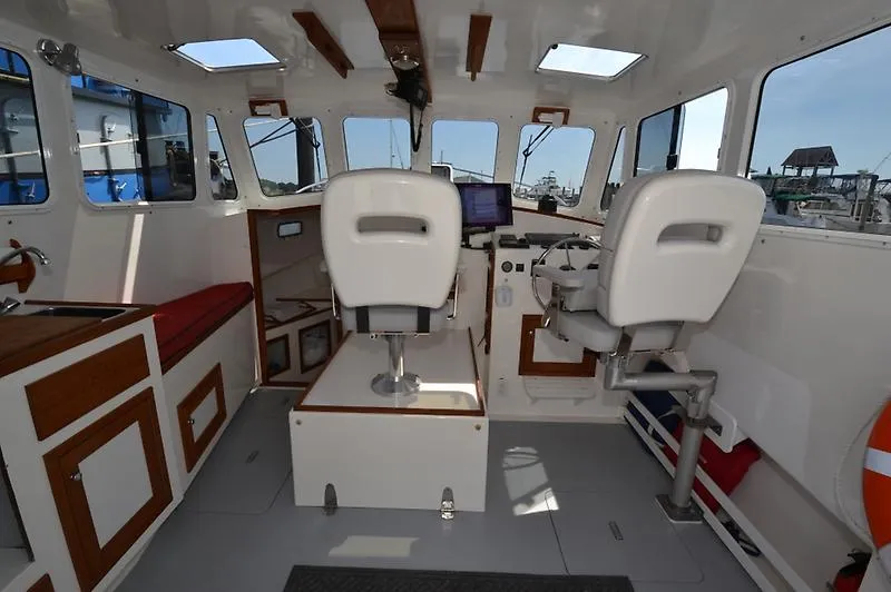 Grey Goose Yacht Photos Pics Interior of a 2002 West Bay 31 boat with helm and seating area.