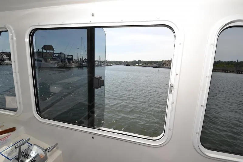 Grey Goose Yacht Photos Pics View from inside a 2002 West Bay 31 boat, overlooking a marina through the window.