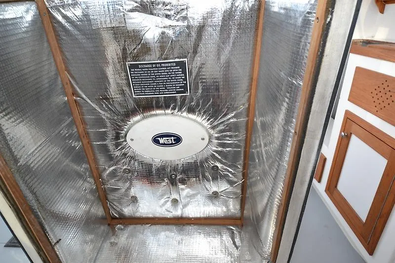 Grey Goose Yacht Photos Pics Insulated compartment in 2002 West Bay 31 boat interior with reflective material.