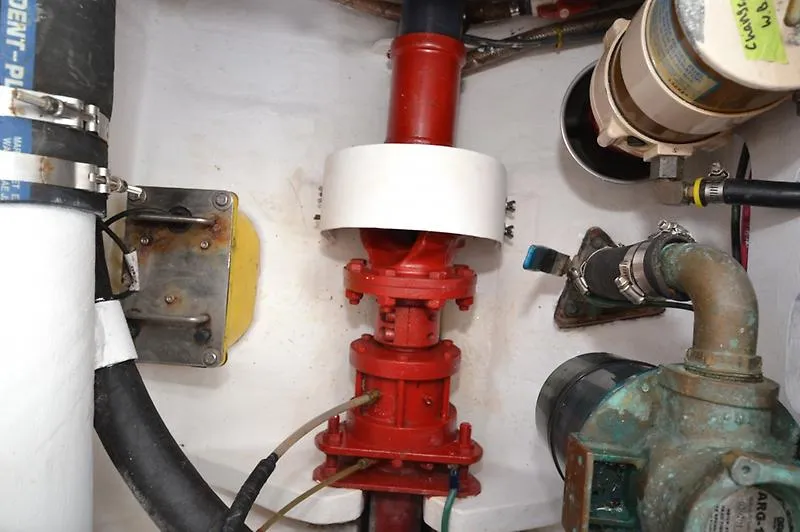 Grey Goose Yacht Photos Pics Engine compartment of a 2002 West Bay 31 boat, featuring red piping and mechanical components.