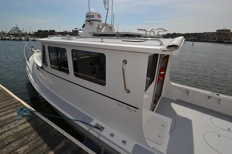 Grey Goose Yacht Photos Pics 2002 West Bay 31 boat docked at marina, side view.