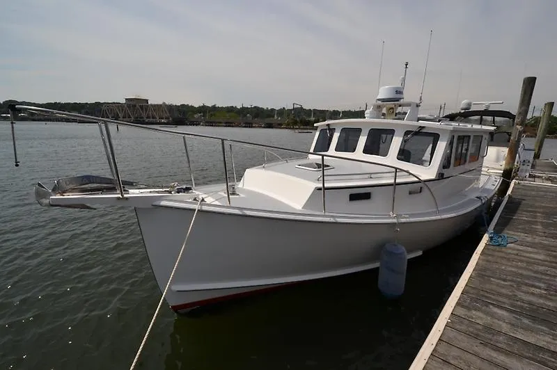 Grey Goose Yacht Photos Pics 2002 West Bay 31 boat docked at a marina, side view.