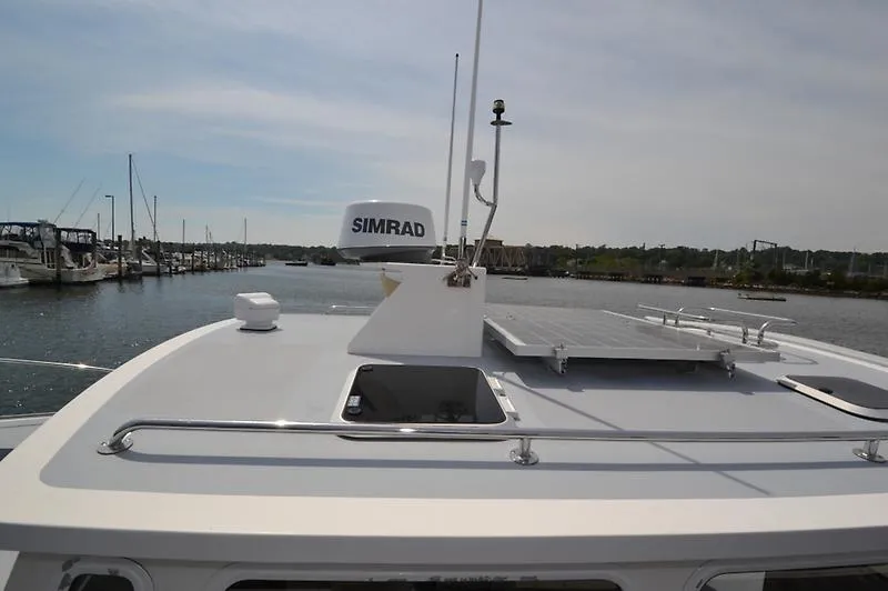 Grey Goose Yacht Photos Pics 2002 West Bay 31 boat with Simrad radar on calm water.