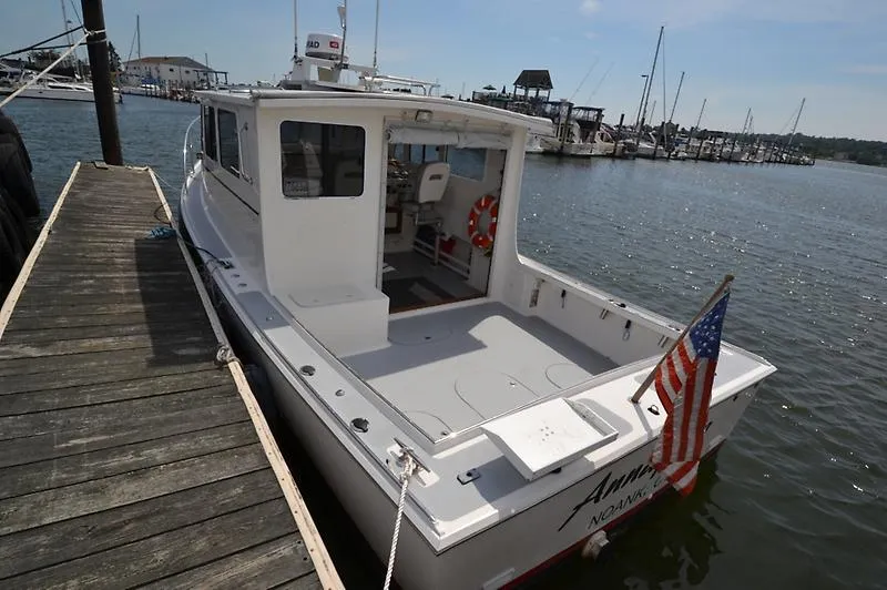 Grey Goose Yacht Photos Pics 2002 West Bay 31 boat docked at marina, American flag displayed.