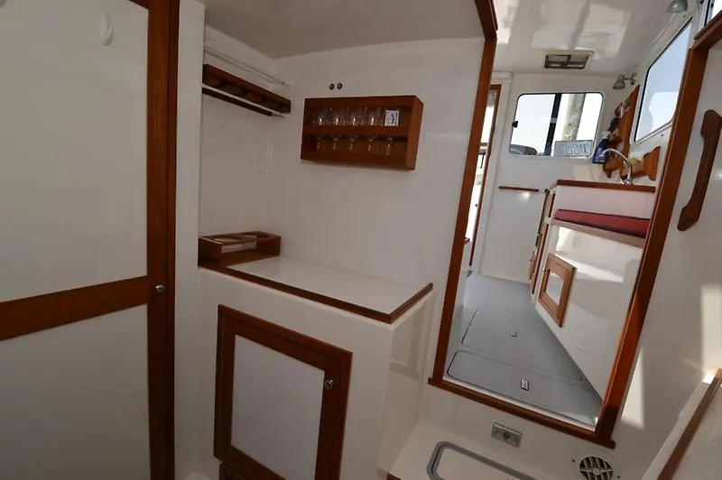Grey Goose Yacht Photos Pics Interior of 2002 West Bay 31 boat with wooden accents and built-in storage.