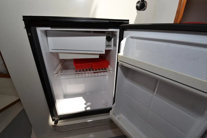 Grey Goose Yacht Photos Pics Open refrigerator inside a 2002 West Bay 31 boat, featuring ice trays and freezer compartment.