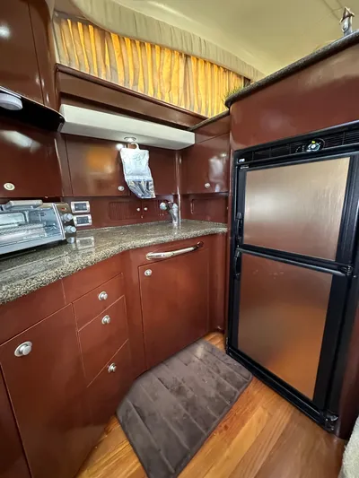 Debs Dinghy Yacht Photos Pics Luxurious kitchen in 2007 Sea Ray 40 Motor Yacht with modern appliances and wood cabinetry.