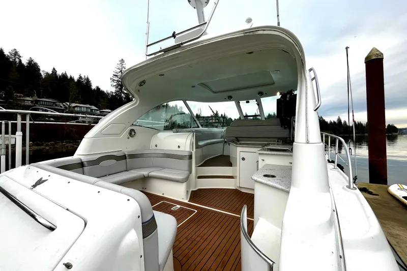 Formula 45 Yacht Photos Pics 2008 Formula 45 Yacht with spacious deck and seating, docked by serene waters.