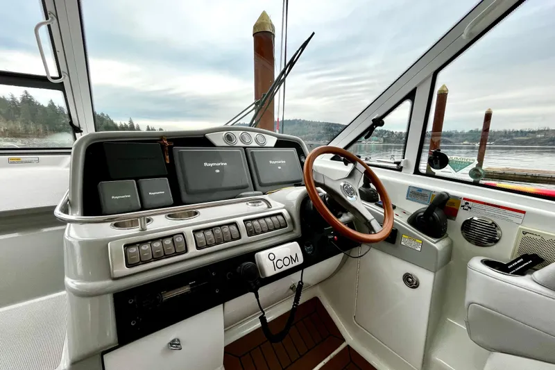 Formula 45 Yacht Photos Pics 2008 Formula 45 Yacht helm with Raymarine navigation, wooden steering wheel, and Icom radio.