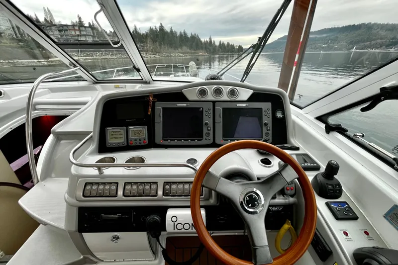 Formula 45 Yacht Photos Pics 2008 Formula 45 Yacht cockpit with steering wheel, navigation screens, and control panel.