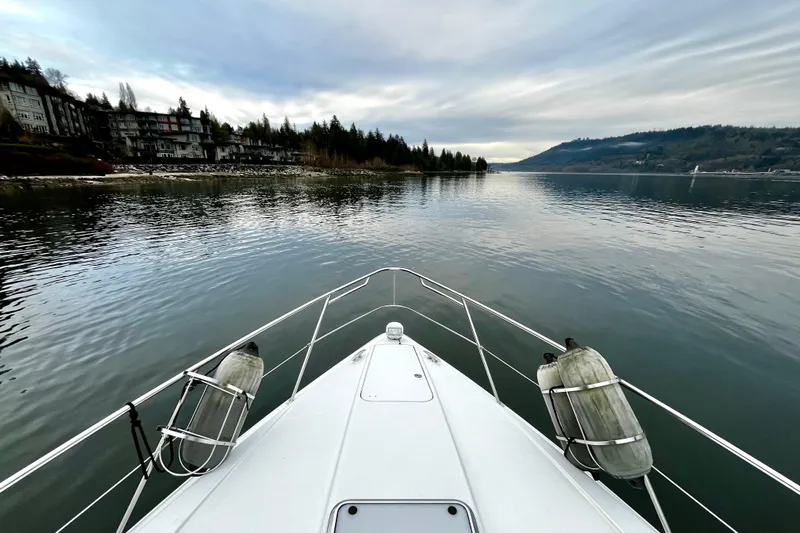 Formula 45 Yacht Photos Pics Bow view of 2008 Formula 45 Yacht cruising on a serene lake with scenic shoreline.