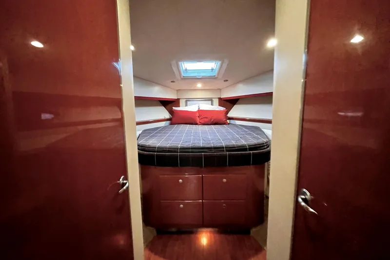 Formula 45 Yacht Photos Pics Luxurious cabin interior of 2008 Formula 45 Yacht with cozy bed and elegant wood finish.