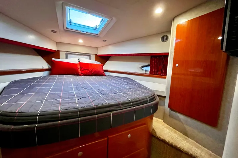Formula 45 Yacht Photos Pics Luxurious cabin interior of 2008 Formula 45 Yacht with cozy bedding and elegant wood finishes.