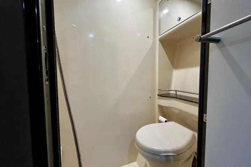 Formula 45 Yacht Photos Pics Bathroom interior of 2008 Formula 45 Yacht, featuring toilet and storage shelves.