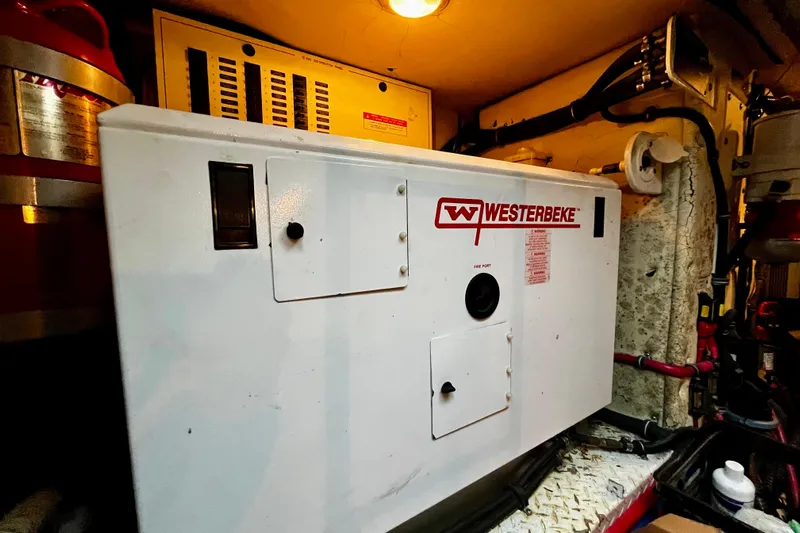 Formula 45 Yacht Photos Pics Westerbeke generator in 2008 Formula 45 Yacht engine room, illuminated and surrounded by equipment.